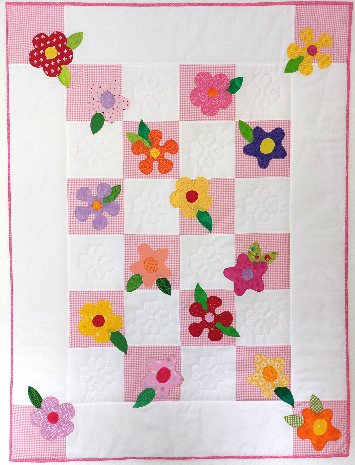 the whole front of the pink check and white patchwork quilt which shows all the flowers and leaves sewn on
