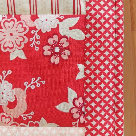 A close up of one of the red flower patches and the red and cream border