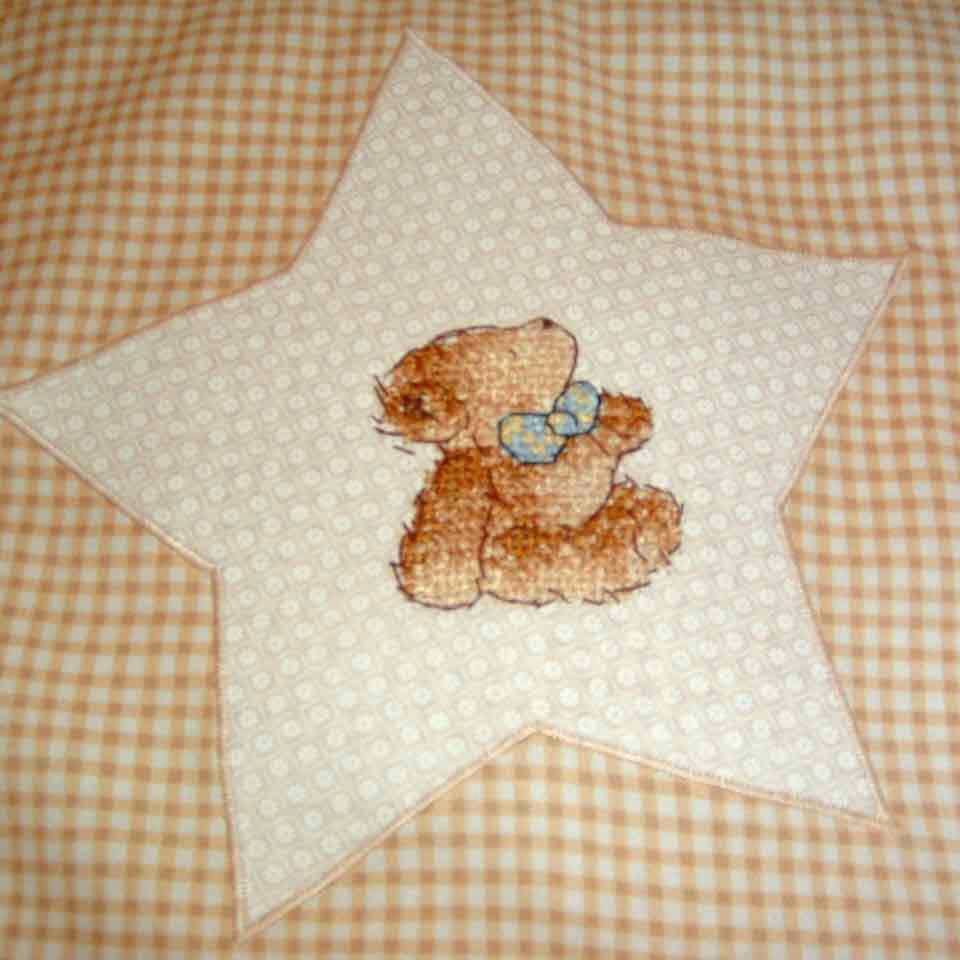 close up of a star with a cross-stitched bear
