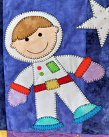 a boy astronaut in a space suit floating around in space