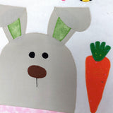 Children's quilt with a bunny face and carrot design on a white background