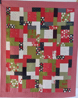 Patchwork quilt with a geometric pattern on a red background