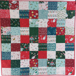 cozy Christmas patchwork baby quilt with various patterns and colours