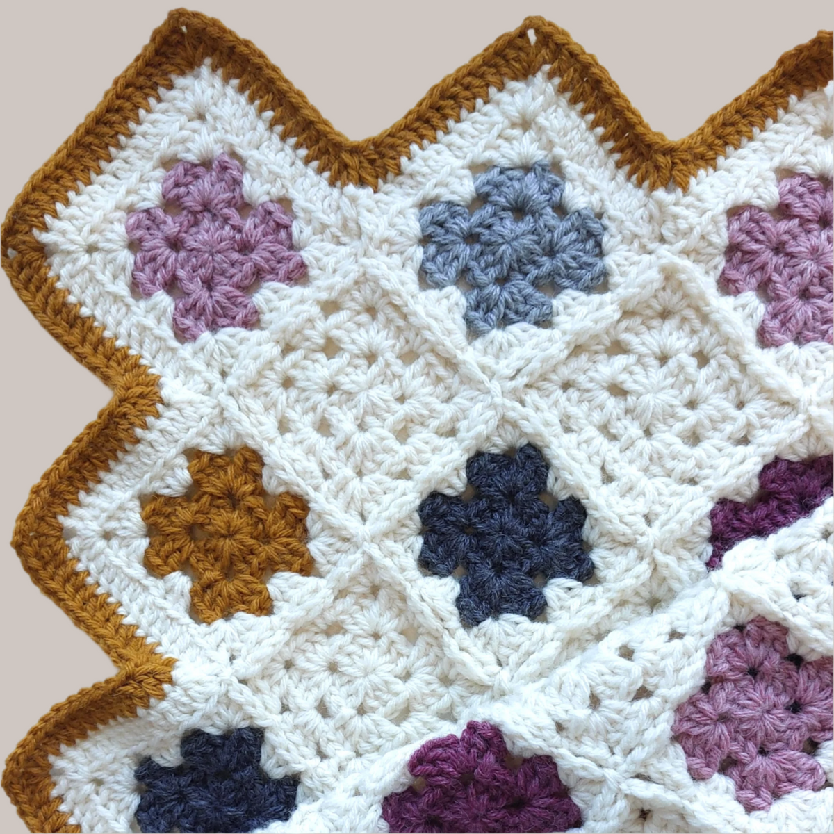 corner of the handmade crochet baby blanket showing the yellow border