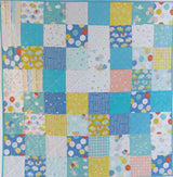 delivered with love patchwork baby quilt with colourful square patterns of balloons, elephants and stars