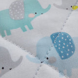 Close-up of a quilt with blue and gray elephant patterns on a white background
