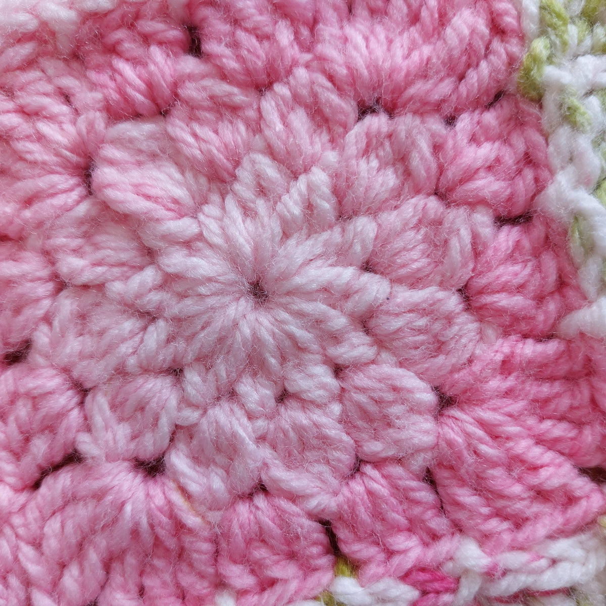 a light pink flower square changing to a darker pink at the edges of the square