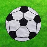 a black and white football on a green background