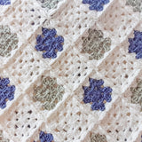 close up of crochet squares in this baby blanket in cream, green and blue