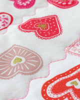 fabric showing small hearts in different colours of red, pink and gold