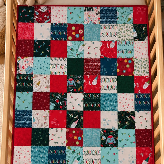 an overhead view of a patchwork quilt in a wooden cot showing patches of Christmas fabric