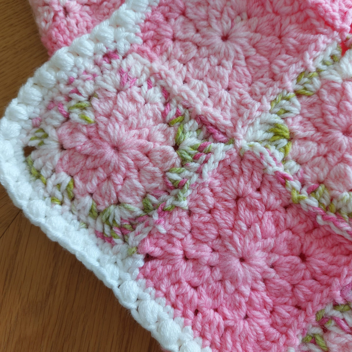 a corner of the blanket showing a white bobble border