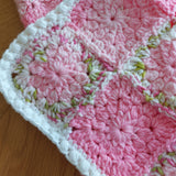 a corner of the blanket showing a white bobble border