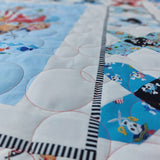 Close-up of a quilt with colorful patterns and a striped border