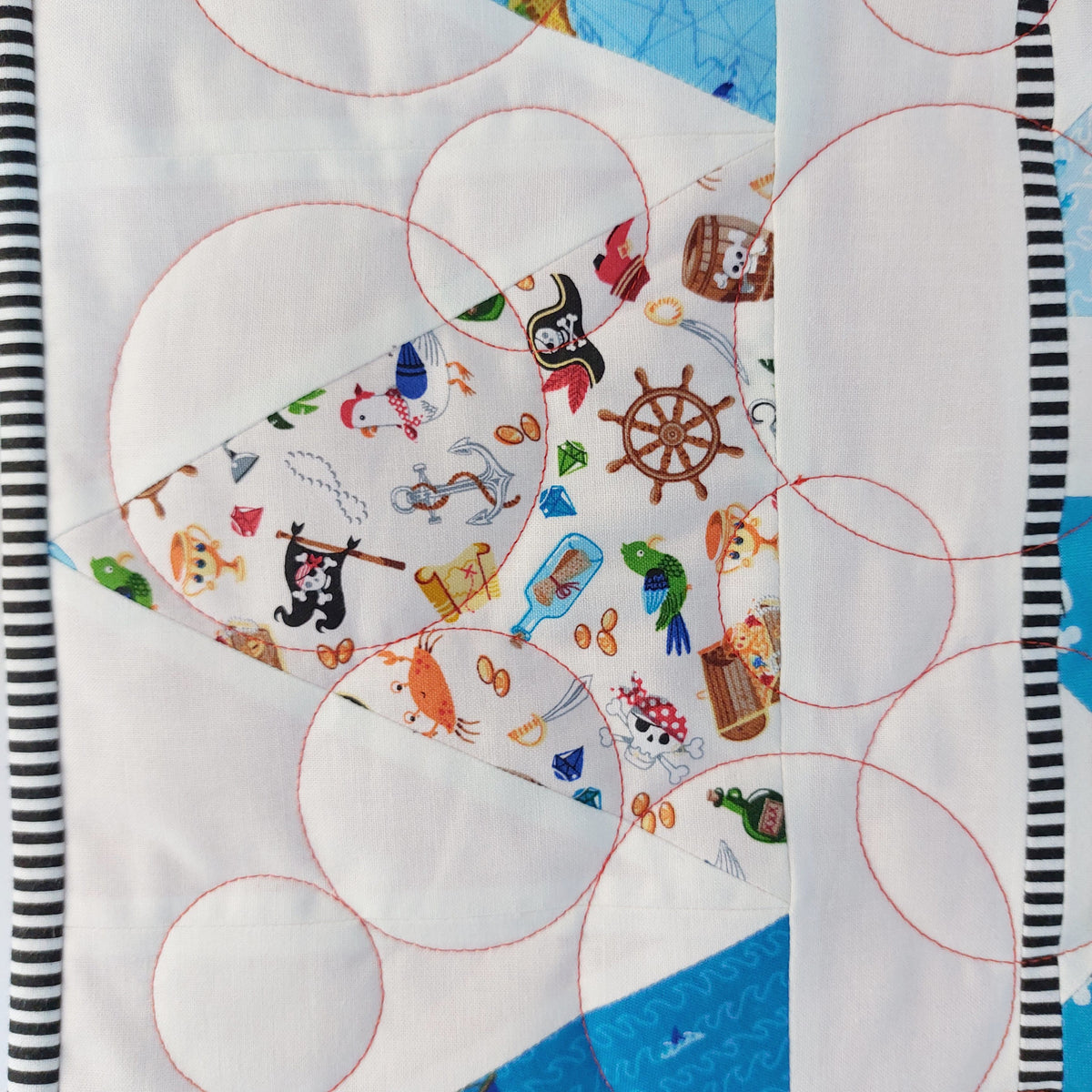 Children's fabric with pirate-themed patterns on a white background