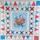 Children's quilt with pirate ship design and colorful triangle patterns