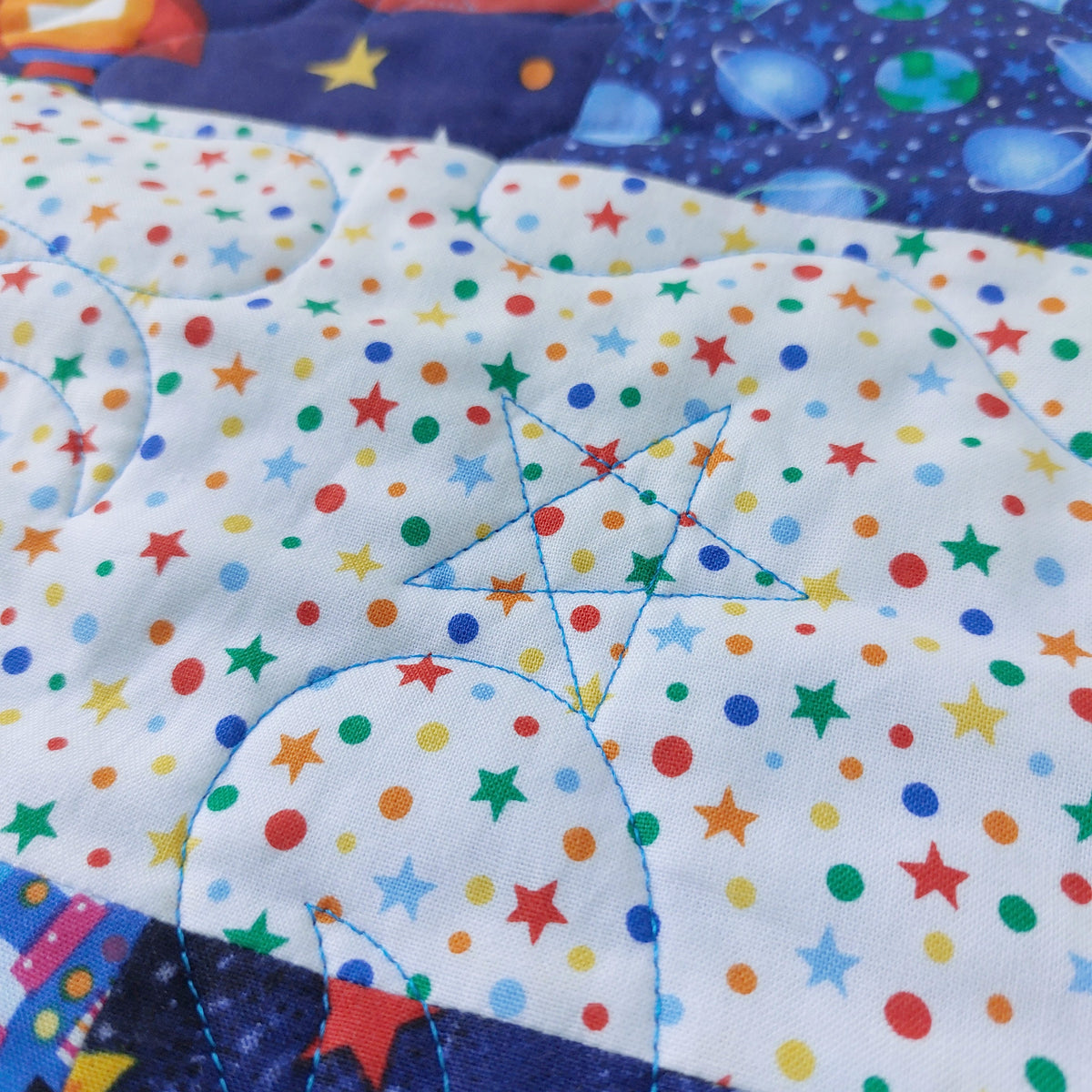 Colorful star and dot pattern on a quilt