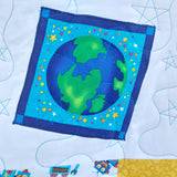 Fabric square with a colorful depiction of the Earth on a blue background, surrounded by stars and space-themed elements.