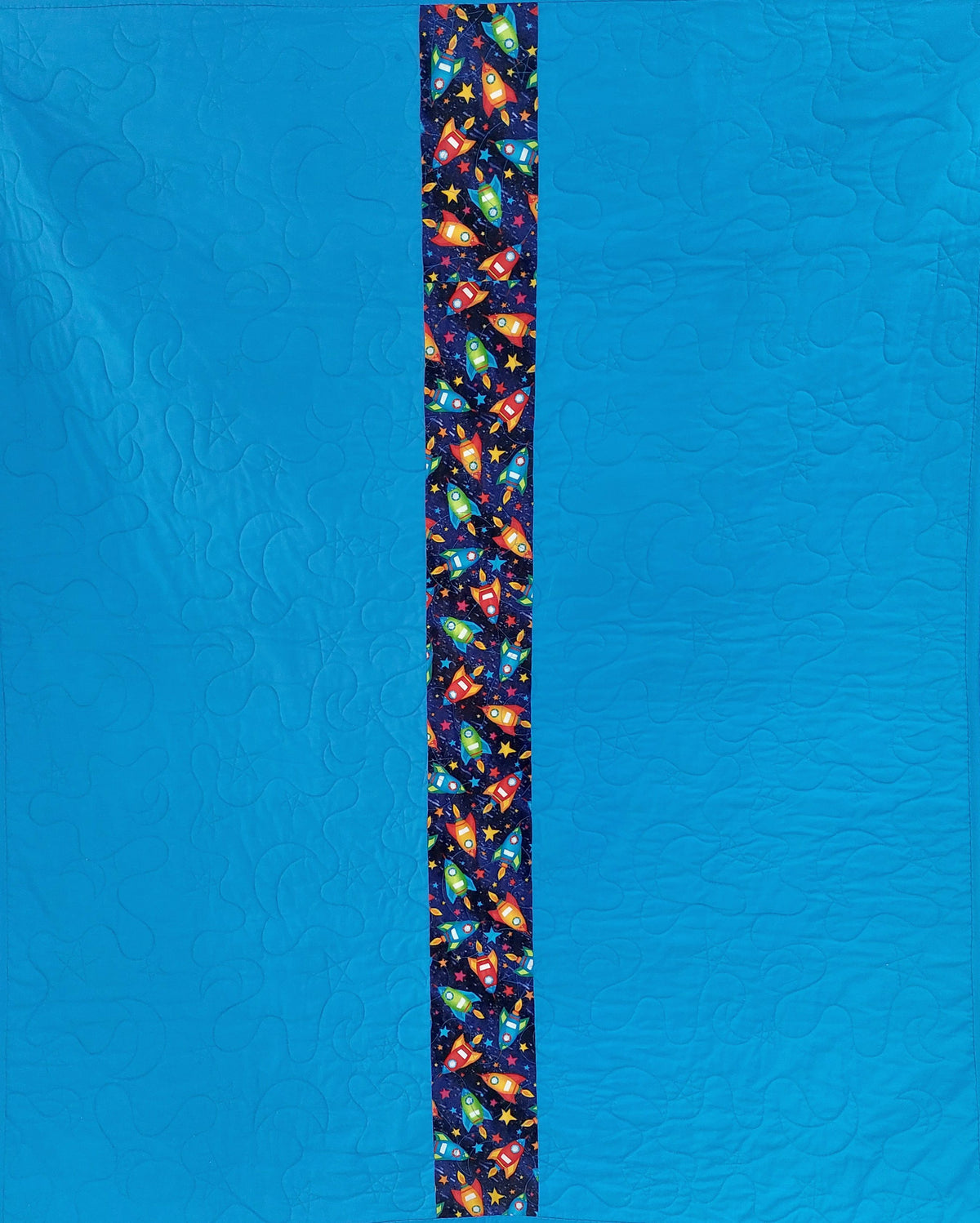 the back of the rockets and robots quilt which is blue with stars and moons quilting