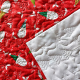 Red fabric with Santa Claus pattern and white textured fabric