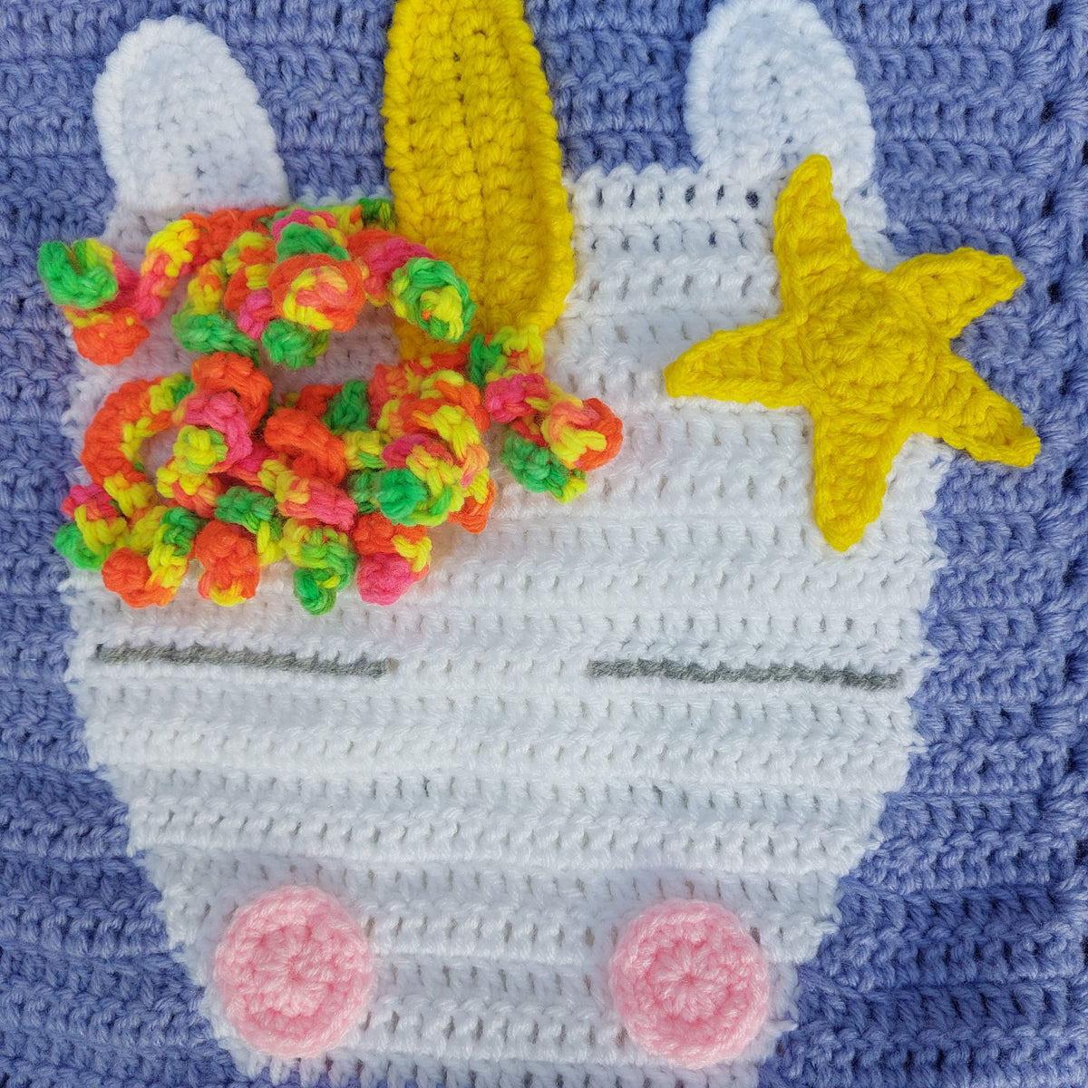 a white unicorn head with pink cheeks and grey eyes with a mane and horn on a purple background