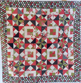 Quilt with geometric pattern featuring red, green, and black colors.