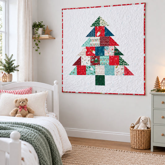 A Christmas tree quilted wall hanging with a patchwork design in red, green, and white, styled in a cozy child's bedroom next to a white bed and light gray dresser.