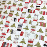 Patterned fabric with Christmas tree designs in red, green, and white.