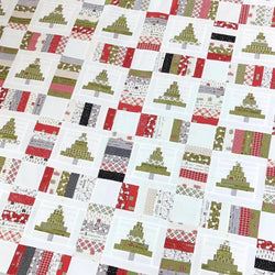 Patterned fabric with Christmas tree designs in red, green, and white.