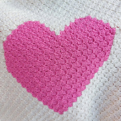 close up of the texture of the pink heart on the handmade pink heart baby blanket