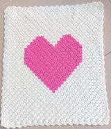 the handmade pink heart crocheted baby blanket laid of flat