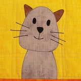 bright yellow background fabric with a light brown cat sew. the cat has black whiskers and dark brown ears