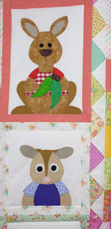 a portion of the land down under quilt showing kangaroo with some green eucalyptus branch and a wombat