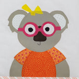 a close up of a koala wearing and orange dress with pink glasses and a yellow bow on her head