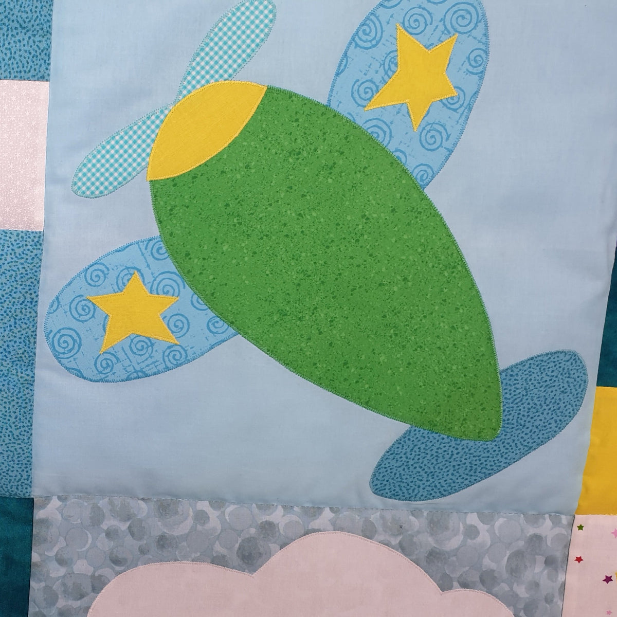 a blue background representing the sky with a green plane with stars on its wings