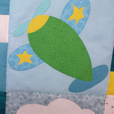 a blue background representing the sky with a green plane with stars on its wings