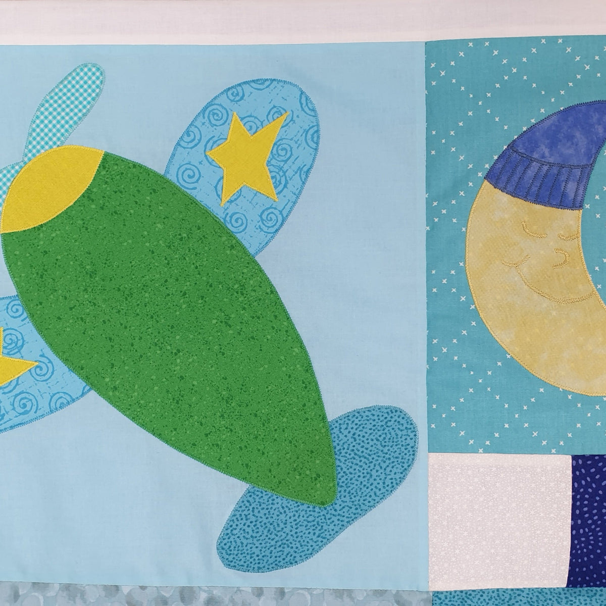 green aeroplane with blue wings flying in a blue sky