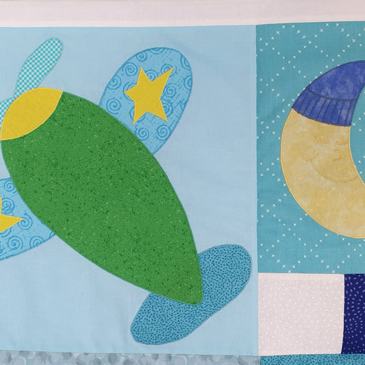 green aeroplane with blue wings flying in a blue sky