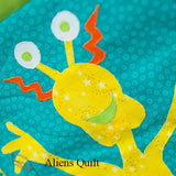 a yellow smiling space alien with orange horns and eyes on stalks