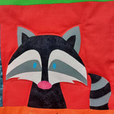 balck and white raccon with a pink nose and blue eyes on a bright red background