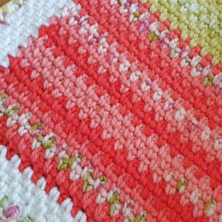 baby blanket stitches shown which change from white rows to a pink and red colour and then to green