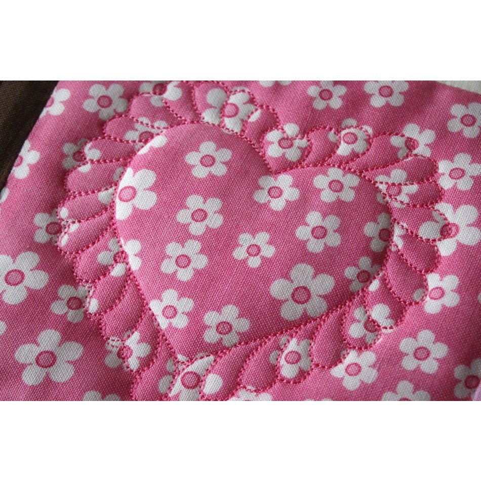 heart shaped quilting on a pink patchwork square