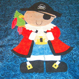 a dark blue fabric background shows off the pirate boy wearing a red coat with blue trousers and a black pirates hat and a parrot on his shoulder
