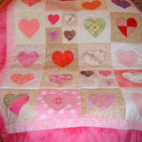 pastel pink hearts on a patchwork quilt
