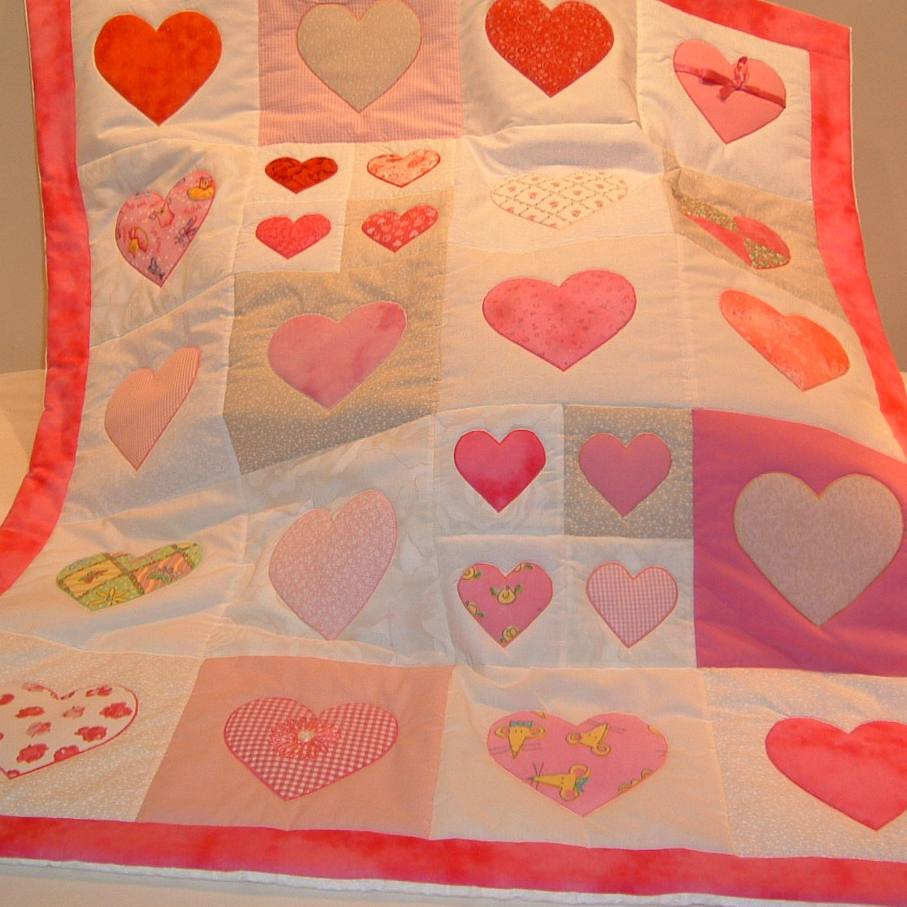patchwork quilt with pink hearts of different colours and sizes