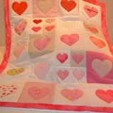 patchwork quilt with pink hearts of different colours and sizes