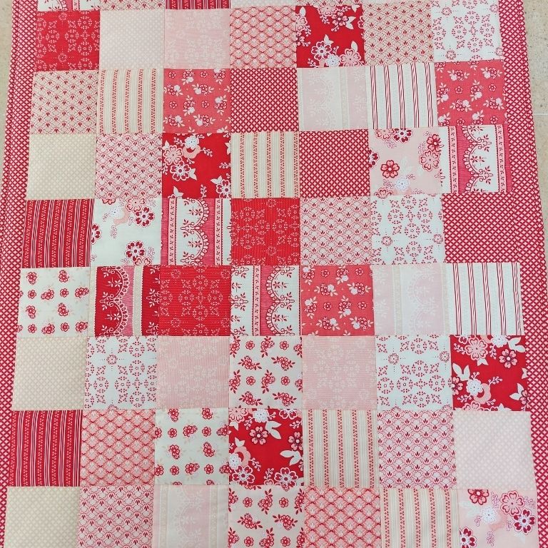 a photo of the total quilt showing all the patches of the patchwork quilt laid out 