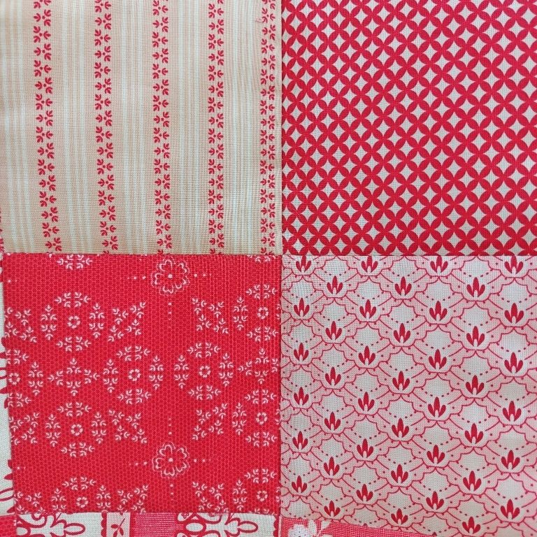 A close up of 4 of the patches making up the patchwork quilt.