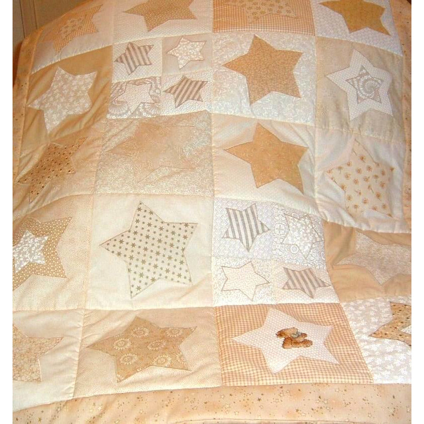 patchwork quilt with cream stars of different colours and sizes