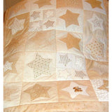 patchwork quilt with cream stars of different colours and sizes